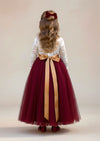 burgundy flower girl dress with lace details, a feathered V‑back, and a full tulle skirt. Includes a complimentary satin sash. Perfect for fall and winter weddings.
