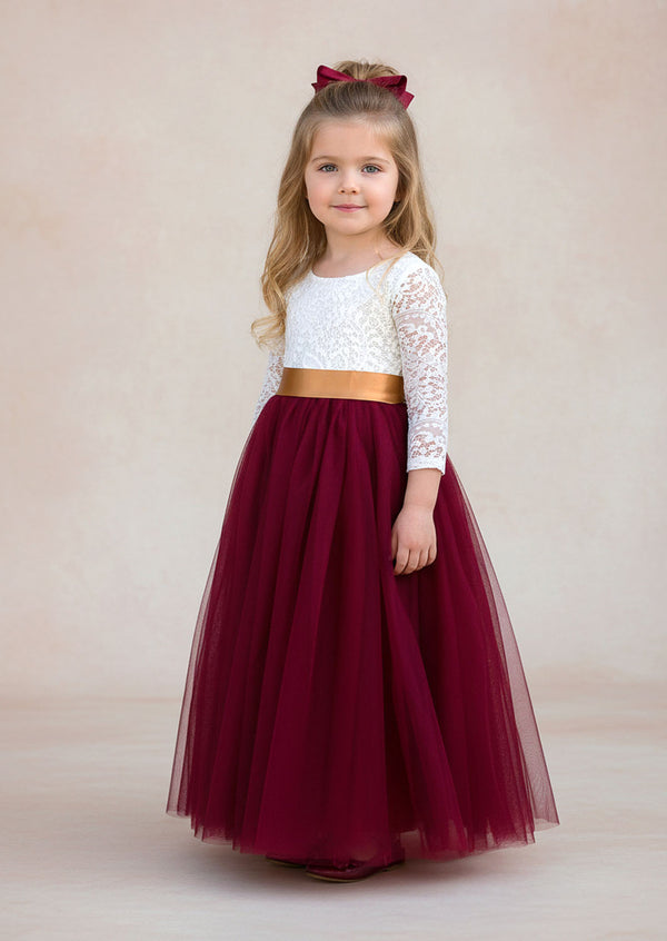 burgundy flower girl dress with lace details, a feathered V‑back, and a full tulle skirt. Includes a complimentary satin sash. Perfect for fall and winter weddings.