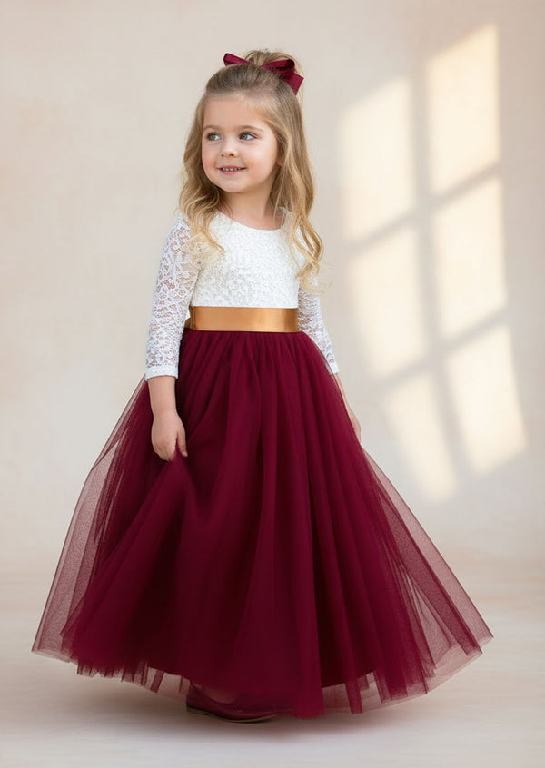 burgundy flower girl dress with lace details, a feathered V‑back, and a full tulle skirt. Includes a complimentary satin sash. Perfect for fall and winter weddings.