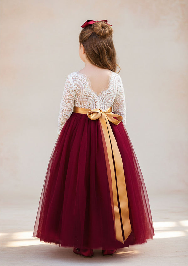 burgundy flower girl dress with lace details, a feathered V‑back, and a full tulle skirt. Includes a complimentary satin sash. Perfect for fall and winter weddings.