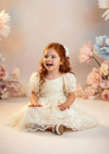 	Ivory embroidered lace flower girl dress with classic knee‑length silhouette