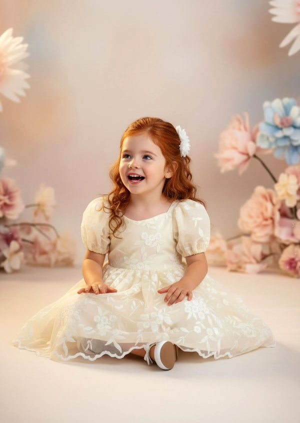 	Ivory embroidered lace flower girl dress with classic knee‑length silhouette
