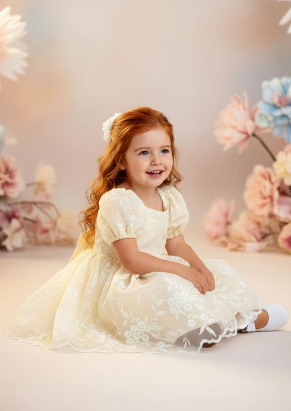 Vintage‑inspired ivory girls dress with puff sleeves and full tulle skirt