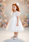 	White knee‑length flower girl dress with embroidered lace bodice and puff sleeves