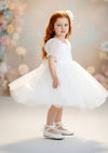 Knee‑length white puff‑sleeve dress perfect for portraits and special occasions