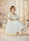 Embroidered lace bodice and ruffled tulle skirt on classic white girls dress