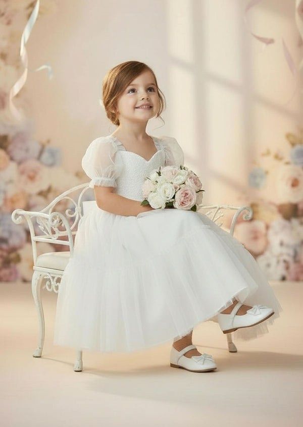 Embroidered lace bodice and ruffled tulle skirt on classic white girls dress