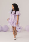 A lavender girls party dress with sequins, puff sleeves, and 3D flower petals. The Magical Balloons & Butterflies Dress is perfect for birthdays, portraits, and whimsical celebrations.
