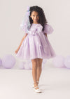 A lavender girls party dress with sequins, puff sleeves, and 3D flower petals. The Magical Balloons & Butterflies Dress is perfect for birthdays, portraits, and whimsical celebrations.
