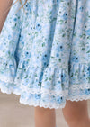 Close-up of a light blue floral dress with lace trim.
