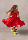 girl spinning in a red twirl dress