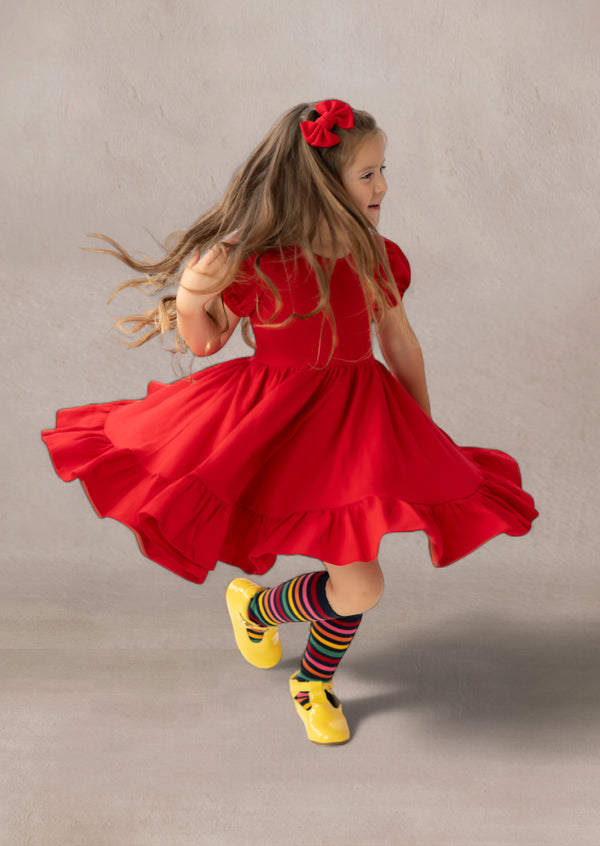 girl spinning in a red twirl dress