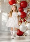 White holiday party dress for toddler girl with puff sleeves and festive bow