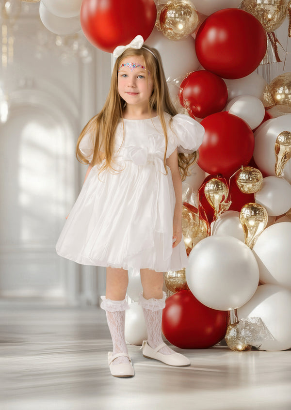 White holiday party dress for toddler girl with puff sleeves and festive bow