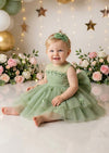 baby girl 1st birthday dress in avocado green sitting