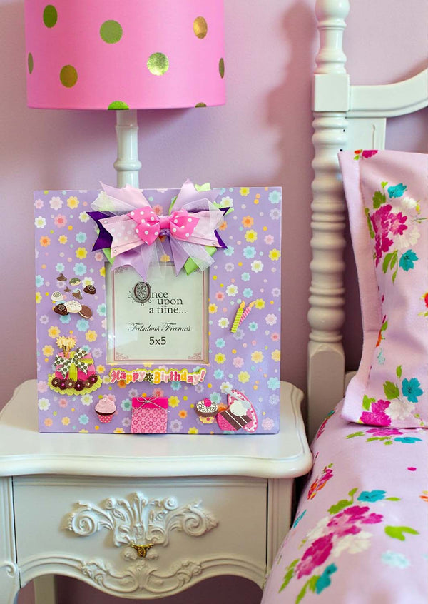 Handmade 11x11" lavender birthday photo frame with pastel floral paper, 3D cake & cupcake accents, ribbon bow, glass insert, and easel back. Holds 5x5" photo. One-of-a-kind and designer-signed.