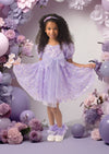 Toddler girl in lavender party dress with puff sleeves, 3D floral appliqués, and sparkling sequins