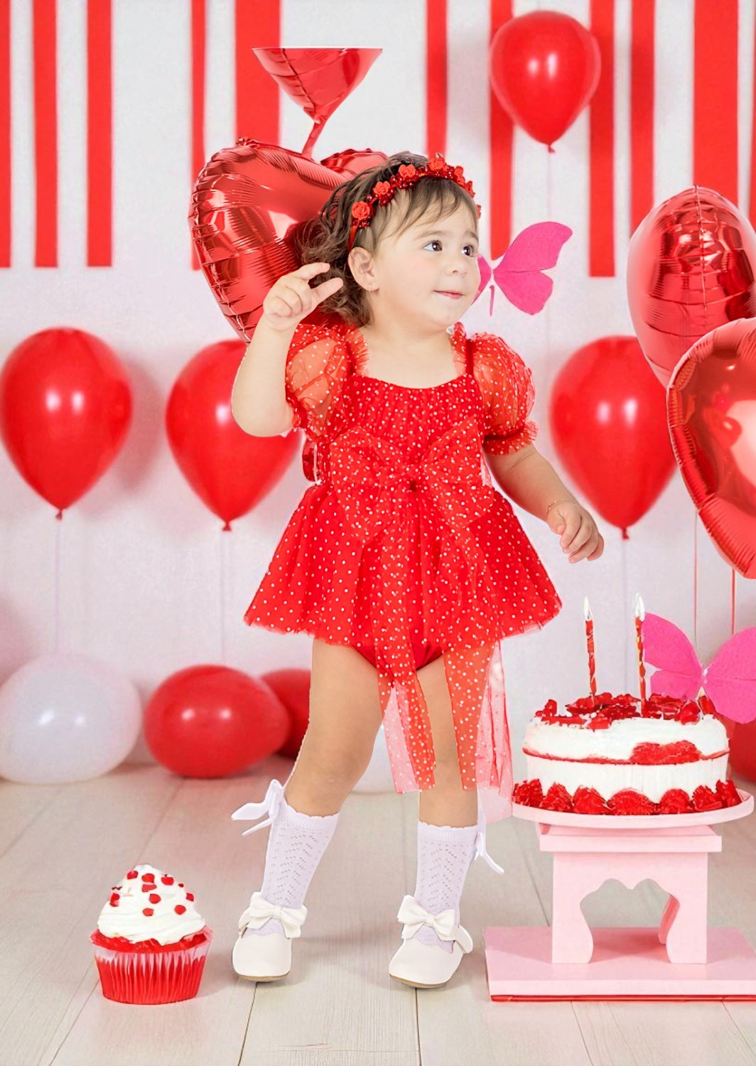 Baby girl red birthday romper with balloons and a cake in the background