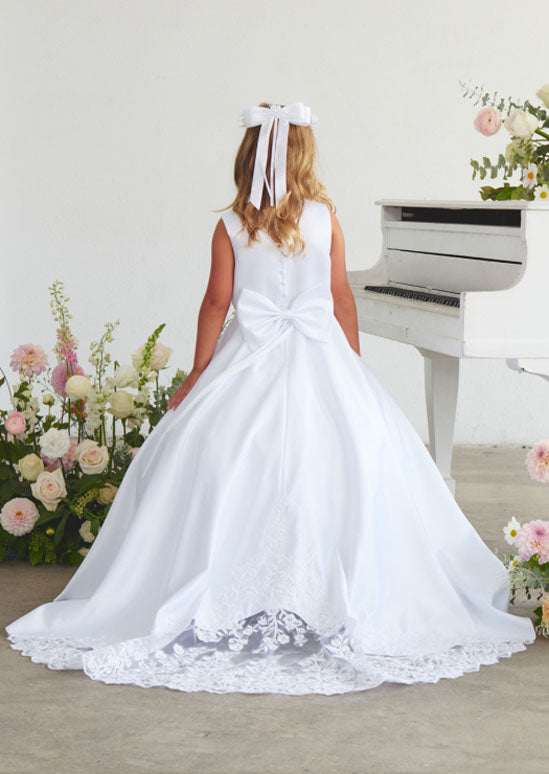 girls white gown featuring a silky satin bodice adorned with delicate lace applique details.