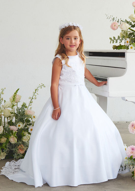 girls white gown featuring a silky satin bodice adorned with delicate lace applique details.