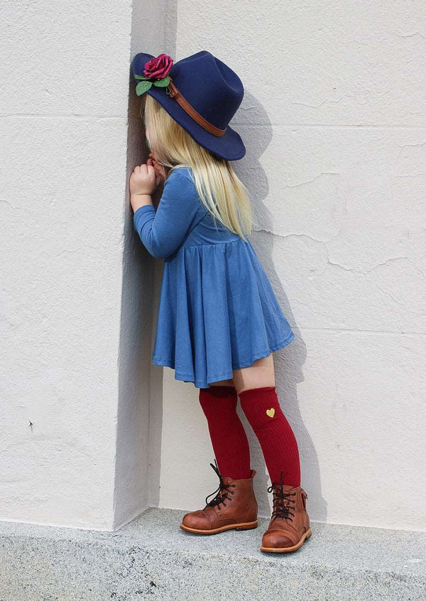 girl in blue dress wearing western hat