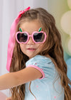 girl wearing pink childrens sunglasses