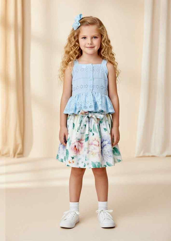 Light blue eyelet embroidered sleeveless top paired with pastel floral skirt spring outfit