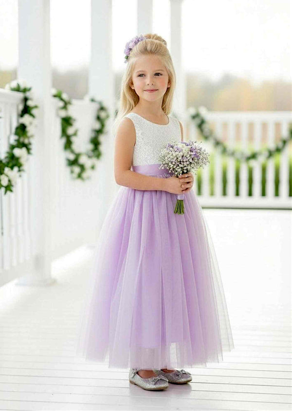 Lavender sleeveless Celine flower girl dress with lace bodice, flowing tulle skirt, and feathered V-lace back