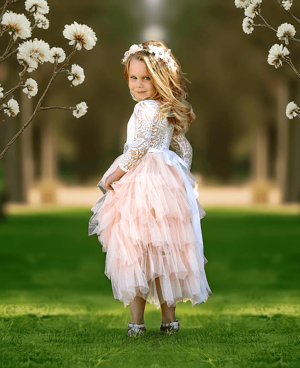 Toddler wearing blush Tabitha layered tulle dress with white lace bodice for weddings