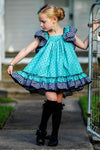 Girls' vintage Grace dress in turquoise cotton with black dots and black-and-white check ruffled hem and bow