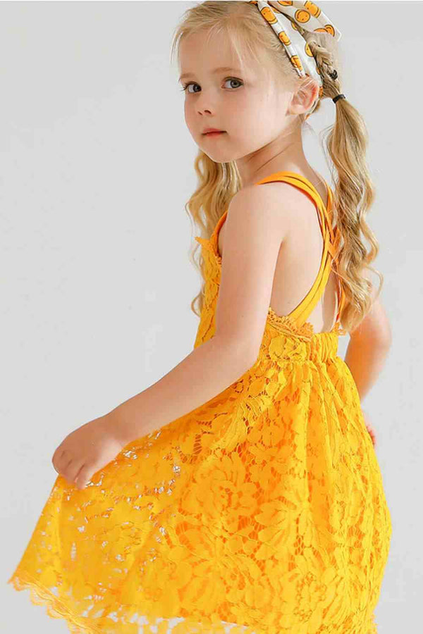 Young girl wearing a sleeveless yellow lace sundress with double spaghetti straps and elastic back